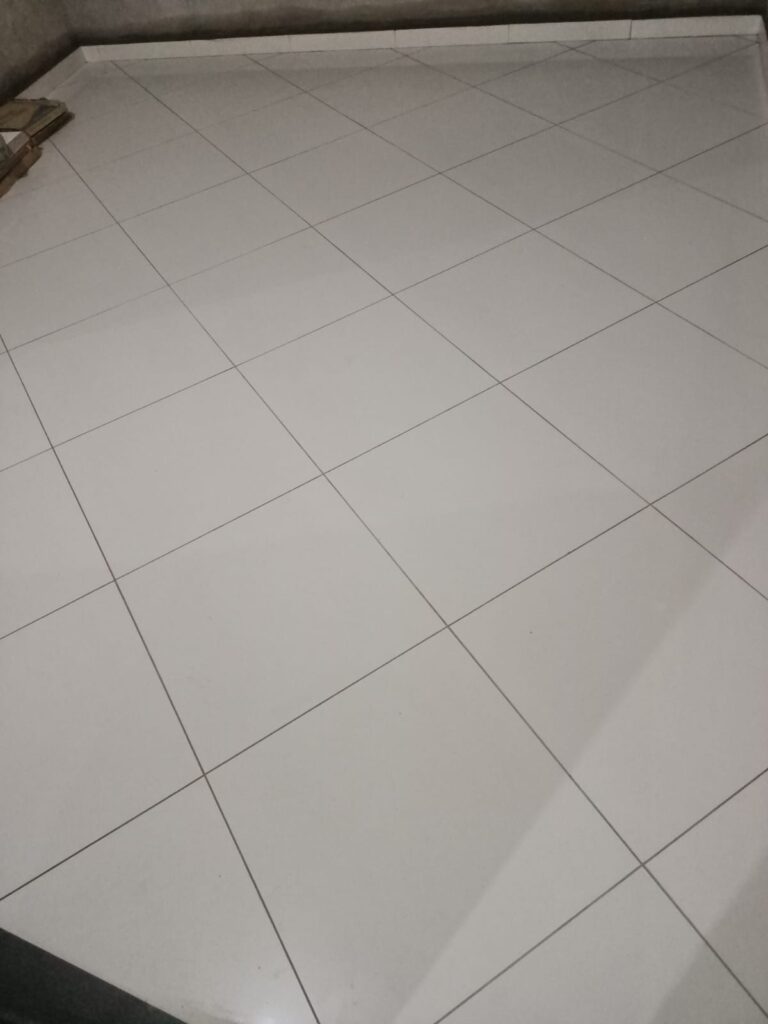 Vitrified tiles fitting on floor by Lalchand Saini tile contractor in Vadodara